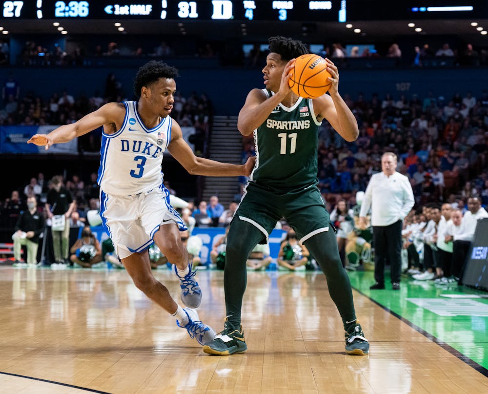 Sophomore A.J. Hoggard (11) defends the ball from freshman Jeremy Roach (3) during Duke's victory over Michigan State on March 20, 2022.
