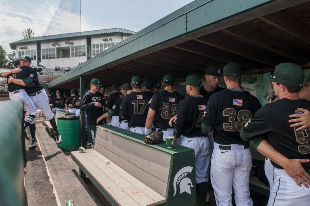 The Spartans hug and high five one another before the game against Nebraska on May 7, 2016 at McLane Stadium.  The Spartans were defeated by the Cornhuskers , 6-3.