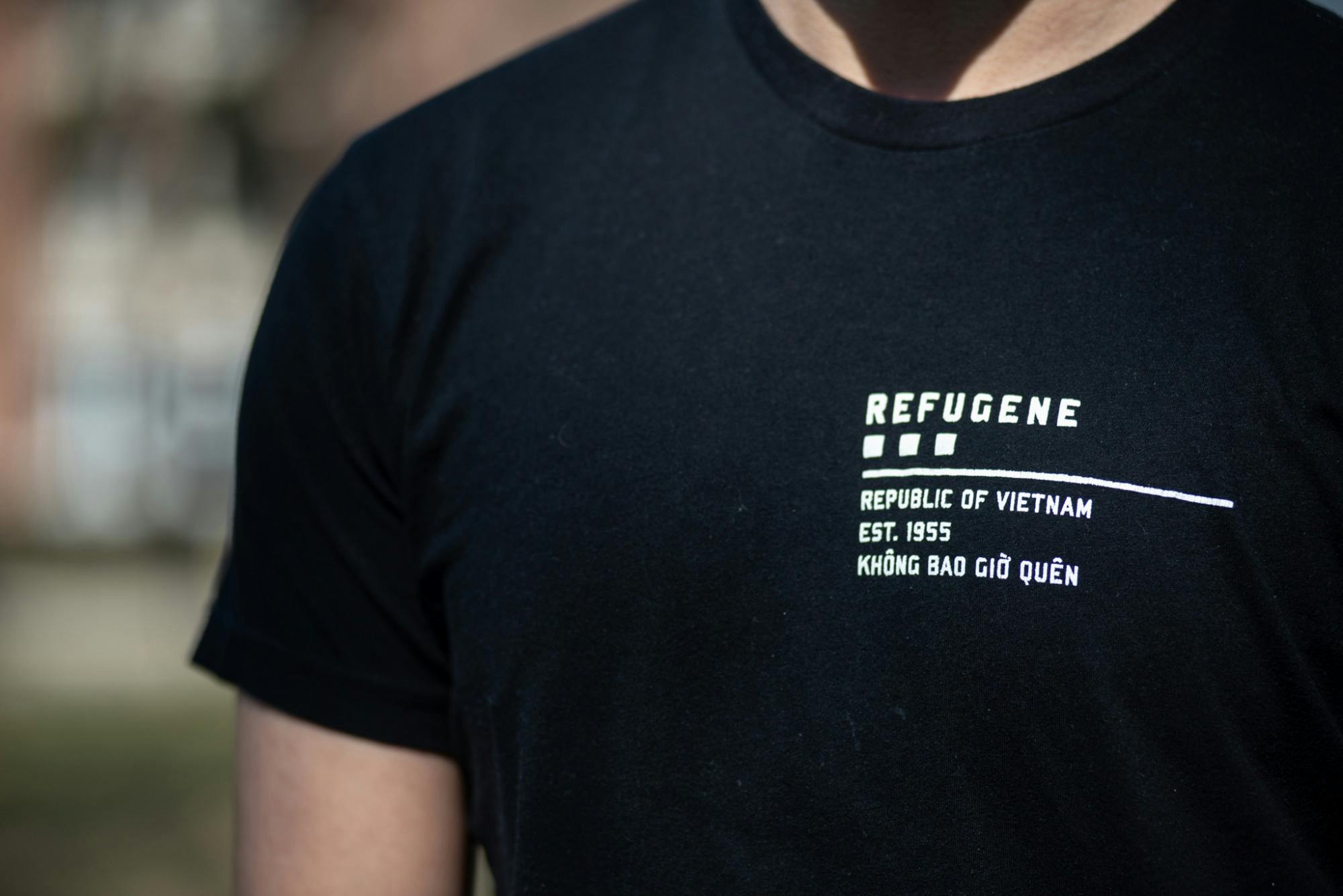 David Tran wears a shirt with the word "REFUGENE" on March 20, 2021. According to the Refugene website, "‘REFUGENE’ is the extraordinary resilience in refugees—the trait we hope to pass from generation to generation. It is in our DNA, either dominant or recessive, and therein lies our mission: Find it in yourself, look for it in others, and live by it for life.”
