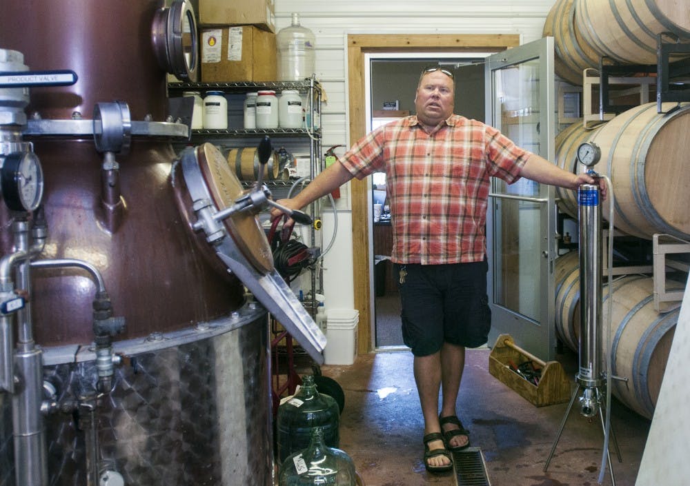 Fifth generation farmer Mike Beck, president of Uncle John's Cider Mill, stands in the Fruit House Winery while working on Wednesday, Aug. 8, 2012. The mill, located at 8614 N. US Highway 127 in St. Johns, Mich., has been in the Beck family for more than a century. Samantha Radecki/The State News