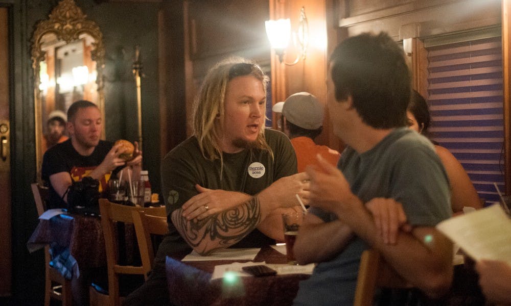 <p>Lansing resident Steve Monti, center, discusses treasurer news during a meeting for Bernie Sanders supporters Sept. 2, 2015, at Clara's Lansing Station Restaurant on Michigan Ave. The supporters meet every Wednesday night to discuss plans to increase awareness for Bernie. Kennedy Thatch/The State News</p>