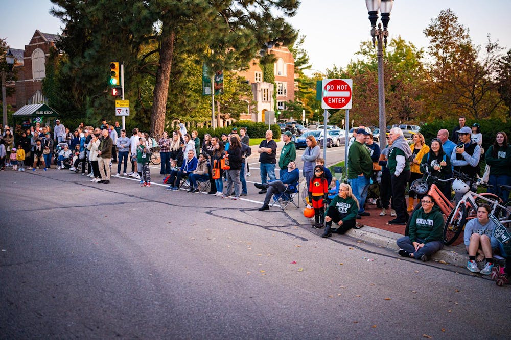 Spectators watch the 2024 MSU Homecoming Parade from Grand River Avenue on Oct. 18, 2024.