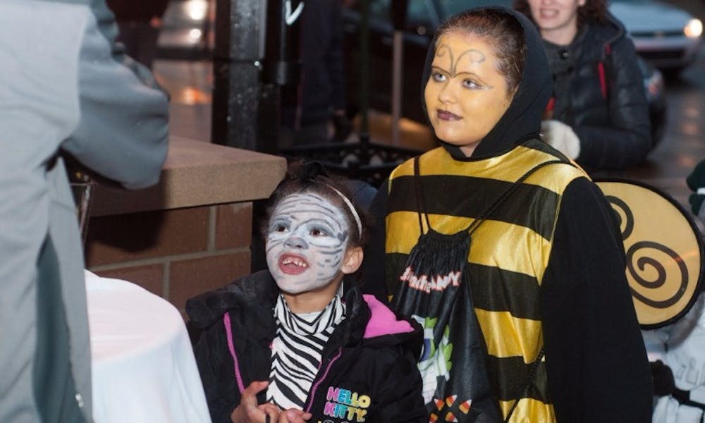 From left to right, Lansing residents Nevaeh Evans, 6, and Roemen Evans, 10, trick-or-treat on Oct. 29, 2015 on MAC Avenue. Navaho and Roemen are participating in Safe Halloween, which is run by the City of East Lansing and allows children to trick-or-treat in a safe environment. Photo: Joshua Abraham