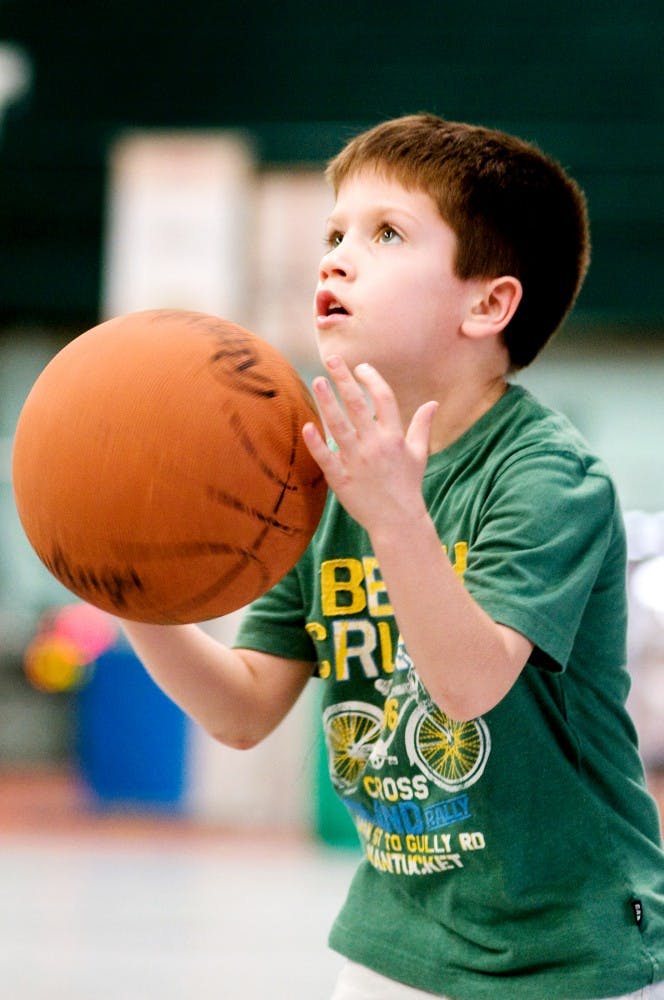 Drew Dowling, 6, of Grand Blanc, eyes up the basket Thursday afternoon at March Magic Hoopfest at Jenison Fieldhouse. Samantha Radecki/The State News