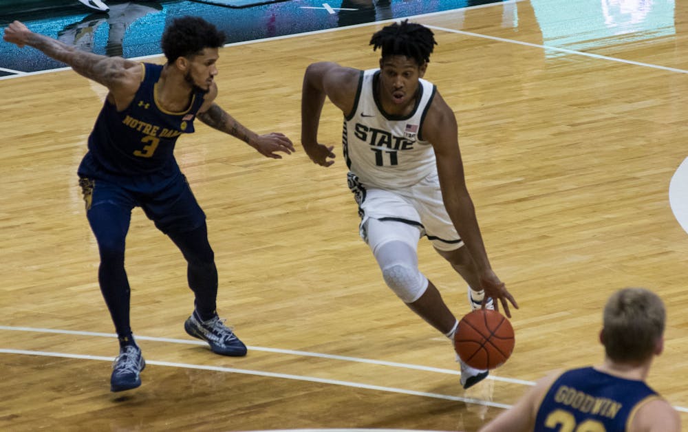 Freshman guard A.J. Hoggard (11) runs the ball towards the Notre Dame basket in the second half. Michigan State triumphed over Notre Dame, 80-70, on Nov. 28, 2020. 