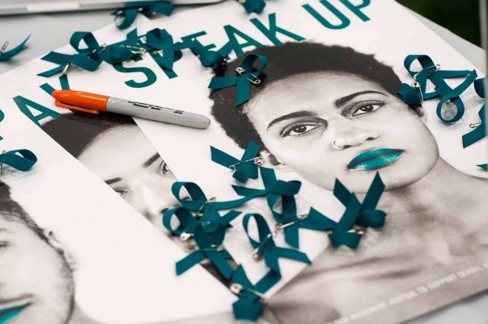 A poster from the "Go Teal" campaign at the It's On Us Day of Action event at Duffy Daugherty Football Building on April 6, 2018. (Annie Barker | State News)