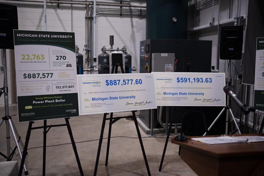 <p>Oversized checks and signage celebrating the university's energy rebates on display in MSU's Simon Power Plant at a media event on March 20th, 2023.</p>