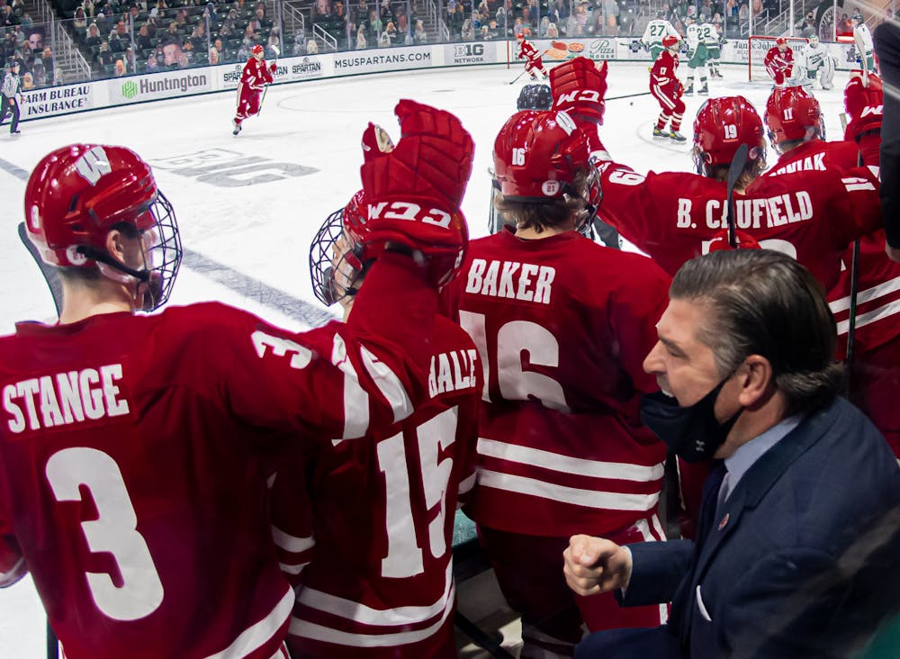 <p>Wisconsin Associate Head Coach Mark Osiecki celebrates a game-tying goal against the Spartans on March 6, 2021. The Badgers went on to complete the comeback victory with another goal in the third period, clinching the Big Ten title.</p>