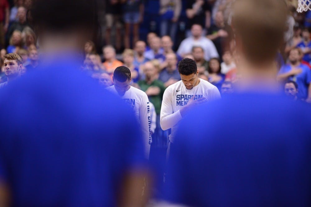 Sophomore forward Kenny Goins (25) stands in silence during the national anthem before the game against University of Kansas in the second round of the Men's NCAA Tournament on March 19, 2017 at  at the BOK Center in Tulsa, Okla.The Spartans were defeated by the Jayhawks, 90-70.