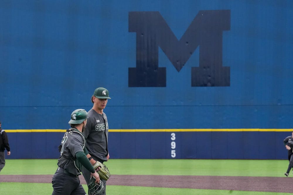 Michigan State redshirt senior Dominic Pianto (26) and graduate student Caleb Berry (31) walk off the field together after an inning on April 26, 2025. The Spartans lost to the Wolverines in the second game 9-2.