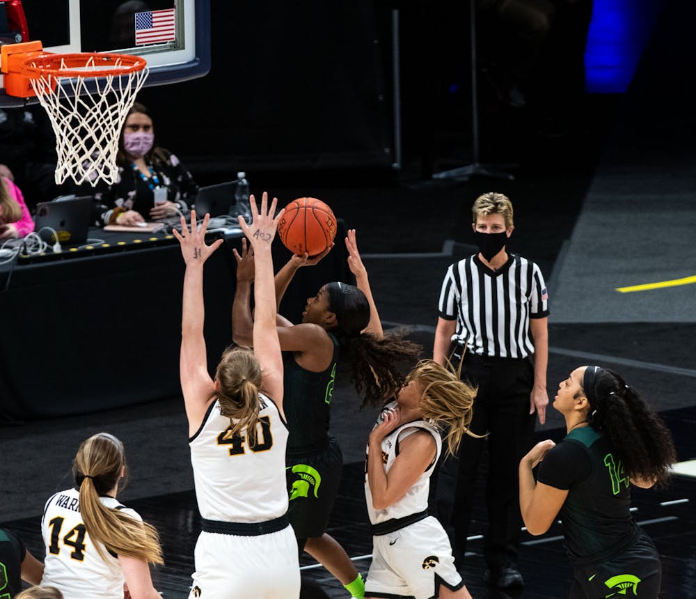 <p>Then-junior guard Nia Clouden (24) jumps up to shoot in the second quarter and is surrounded by Iowa defenders. The Spartans fell to the Hawkeyes, 87-72, in the semifinals of the Big Ten Tournament on Mar. 12, 2021. </p>