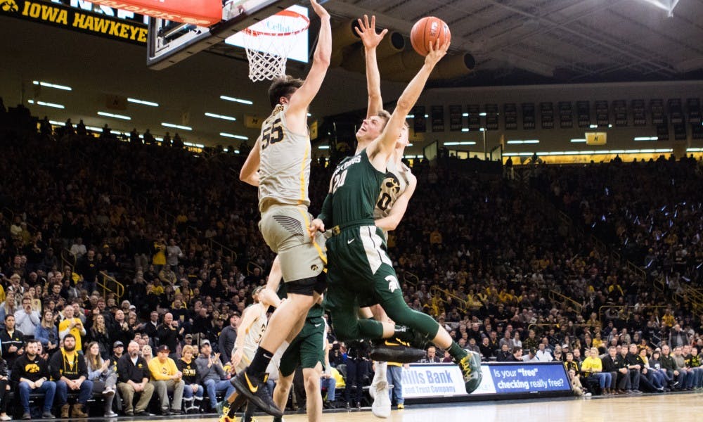 Junior forward Matt McQuaid dunks the ball during the game at Carver-Hawkeye Arena on Jan. 24, 2019. The Spartans trail the Hawkeyes, 35-31, at halftime.