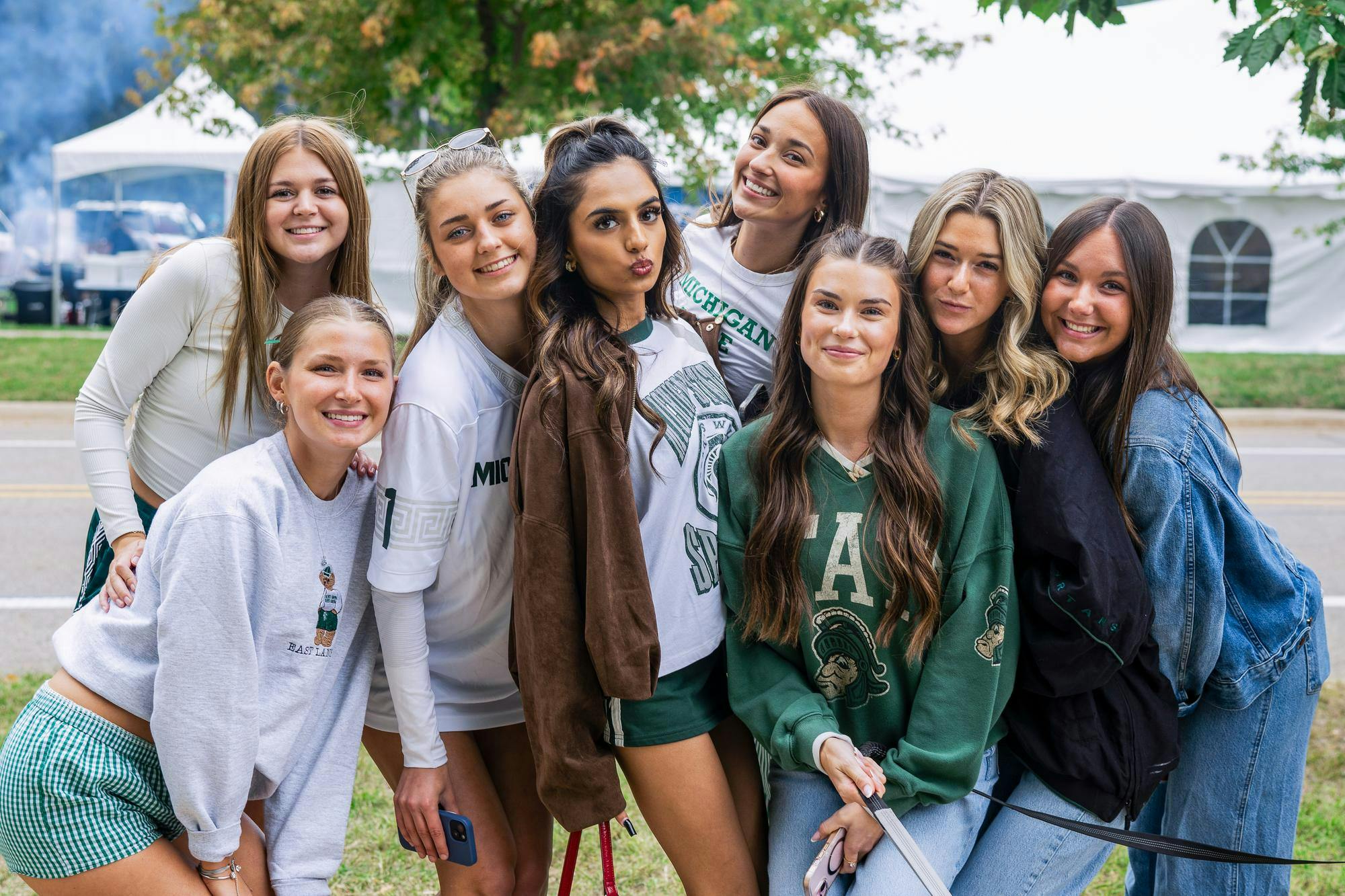 <p>Marissa Kley, Sarina Patel and friends pose while tailgating on Michigan State University’s campus before the football game against Boston College in East Lansing, Michigan, on Sept. 6, 2025.</p>
