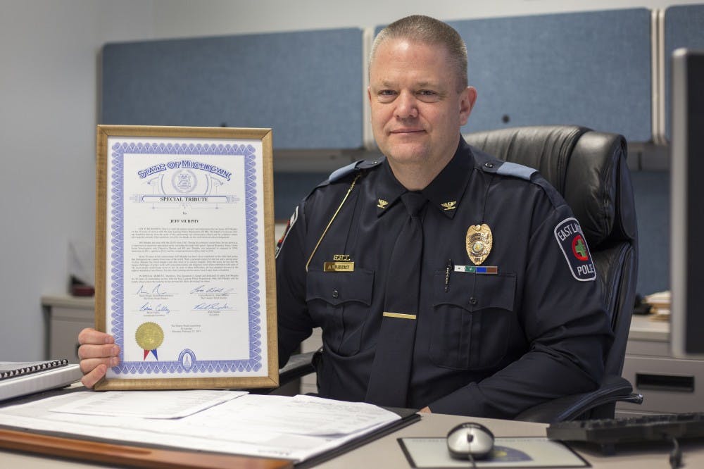 East Lansing's chief of police Jeff Murphy poses for a photo in his office with his 30 years of service award on March 31, 2017 at East Lansing Police Department. Chief Murphy was given a tribute for his 30 years of service to the city. "It really doesn't feel like 30 years," Murphy said.