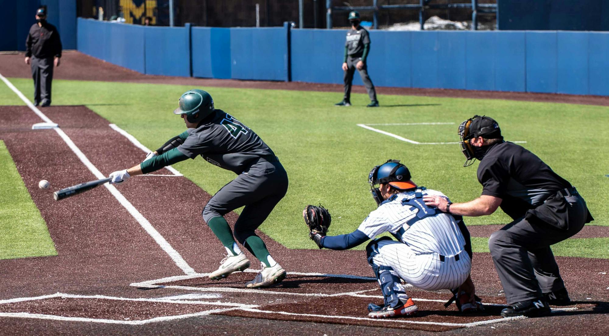 <p>Freshman infielder Mitch Jebb (41) bunts the ball during the fourth inning. The Fighting Illini crushed the Spartans 7-3 at Ray Fisher Stadium on Mar. 21, 2021. </p>