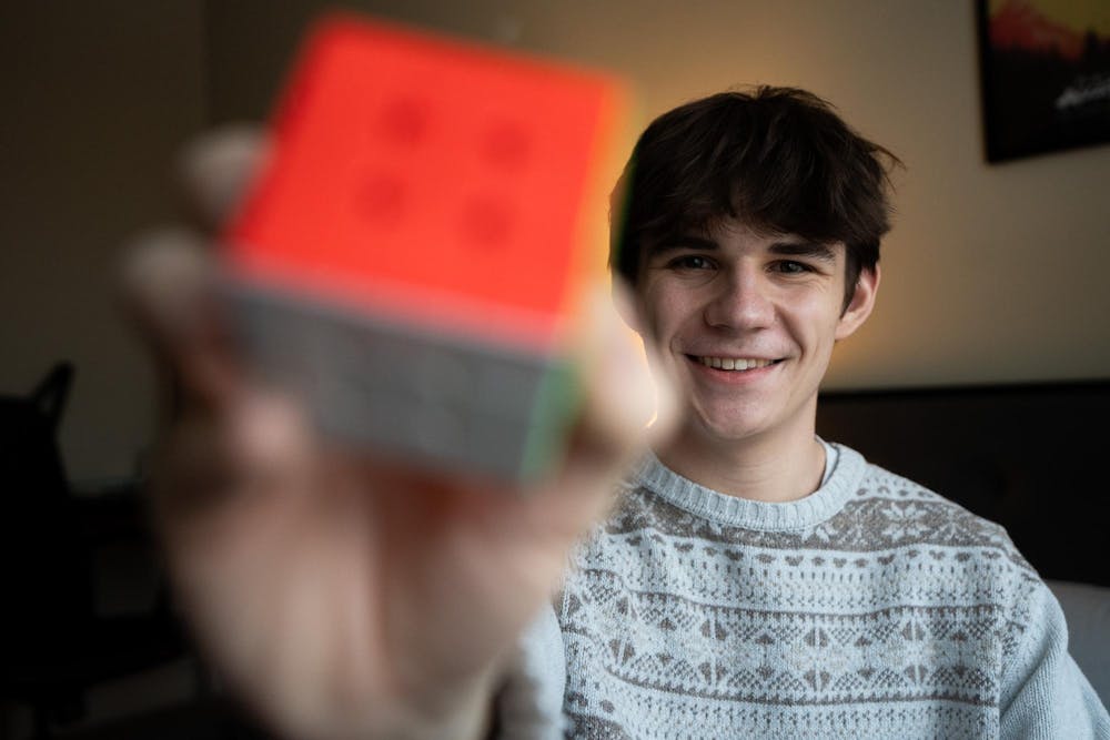 <p>Experience architecture senior Owen Widdis, 22, in his home in East Lansing on Sunday, Feb. 18, 2024. In 2023, Widdis secured the national title in Fewest Moves Challenge at the Cubing USA Nationals.</p>