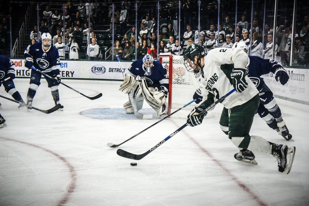 <p>Sophomore right defense Zach Osburn (2) looks to score&nbsp;during the game against Penn State on Feb. 24, 2017 at Munn Ice Arena. The Spartans were defeated by the&nbsp;Nittany Lions, 4-2.</p>