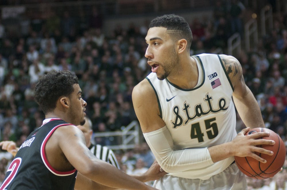 Senior guard Denzel Valentine looks to pass during the second half of the men's basketball game against Louisville on Dec. 2, 2015 at the Breslin Center. The Spartans defeated the Cardinals, 71-67. 