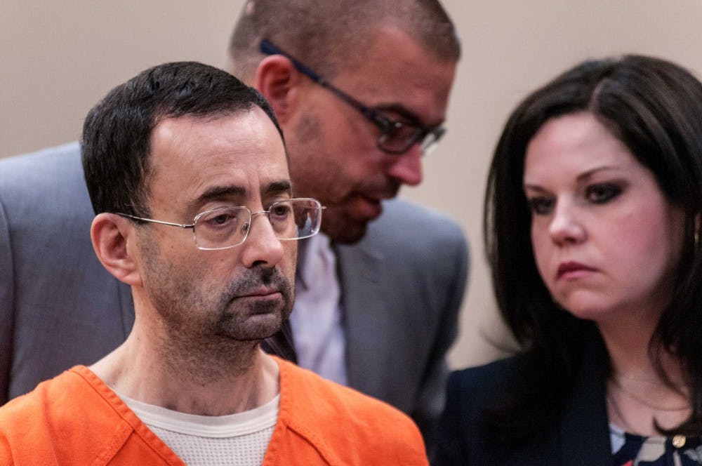 <p>Larry Nassar listens to the judge as his attorneys discuss something behind him during the plea hearing on Nov. 22, 2017, at the Veterans Memorial Court at 313 W Kalamazoo St., Lansing. Nassar pleaded guilty to seven counts.</p>