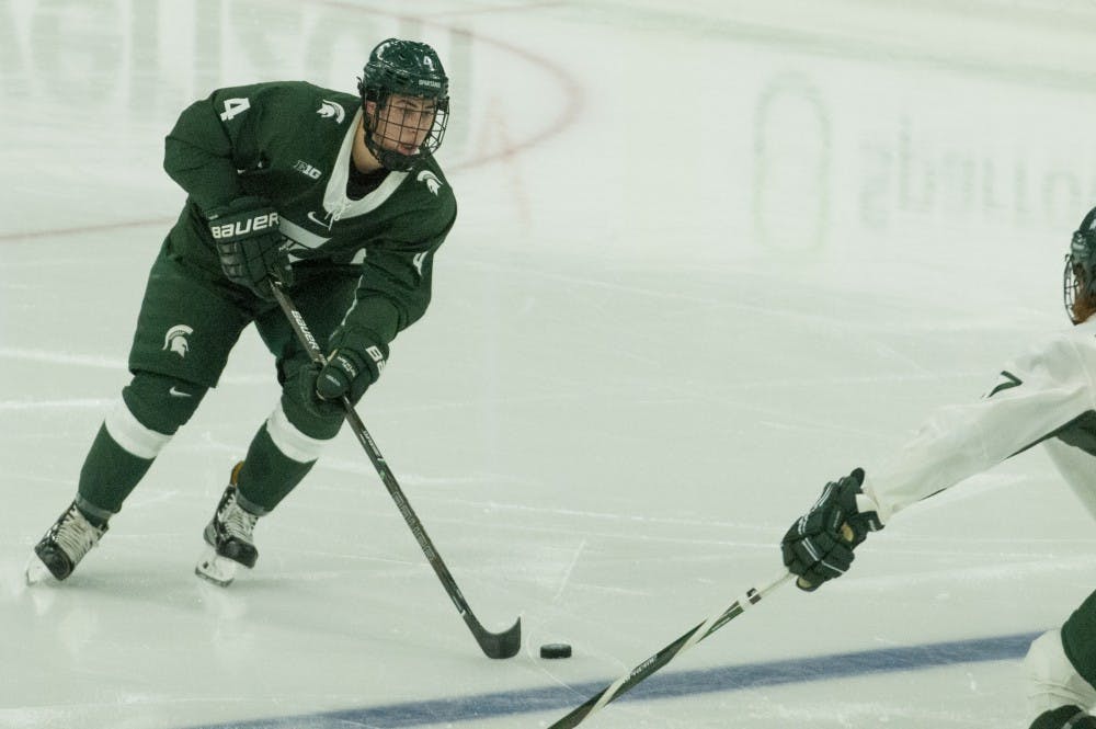 Freshman defenseman Anthony Scarsella (4) skates down the ice during the green white game on Oct. 9. 2016 at Munn Ice Arena. The green team defeated the white team, 5-2. 