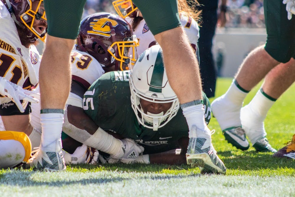 Freshman running back La'Darius Jefferson (15) holds the ball in the endzone after scoring a touchdown during the game against Central Michigan at Spartan Stadium on Sept. 29, 2018. The Spartans defeated the Chippewas 31-20.