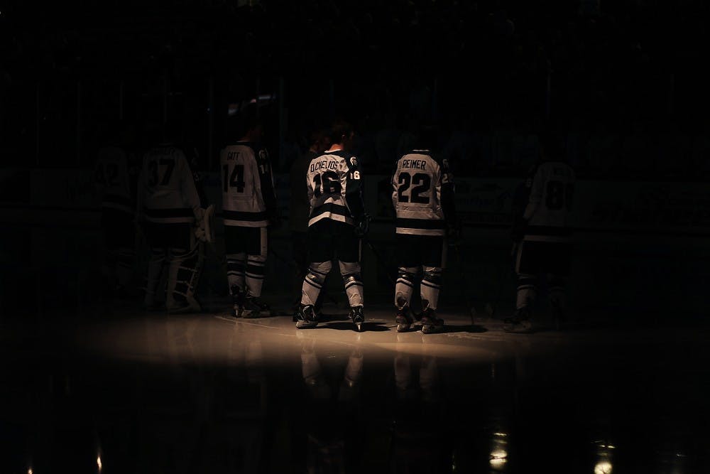 <p>Senior forward Dean Chelios, 16, stands at center ice with graduating seniors before the game against Wisconsin on March 15, 2014, at Munn Ice Arena. The Spartans were defeated by the Badgers, 4-3. Danyelle Morrow/The State News</p>