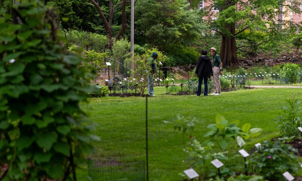 <p>A botanist guides a visitor through the W.J. Beal Botanical Gardens during the 25th anniversary of Lansing’s Be a Tourist in Your Own Town on June 1, 2019.</p>