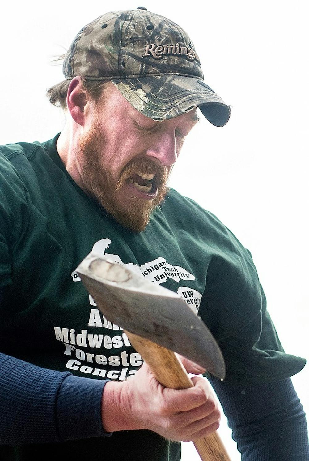 	<p><span class="caps">MSU</span> Forestry Club member Dan Brown grunts as he chops a piece of wood April 6, 2013 at the Ingham County Fairgrounds in Mason, Mich. The event hosted by <span class="caps">STIHL</span> Timbersports featured lumberjack events performed by both professional and collegiate competitors. Adam Toolin/The State News</p>