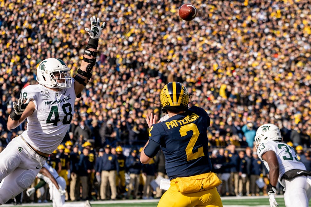 Senior defensive end Kenny Willekes (48) attempts to block a pass form Michigan quarterback Shea Patterson. The Spartans fell to the Wolverines, 44-10, at Michigan Stadium on November 16, 2019. 
