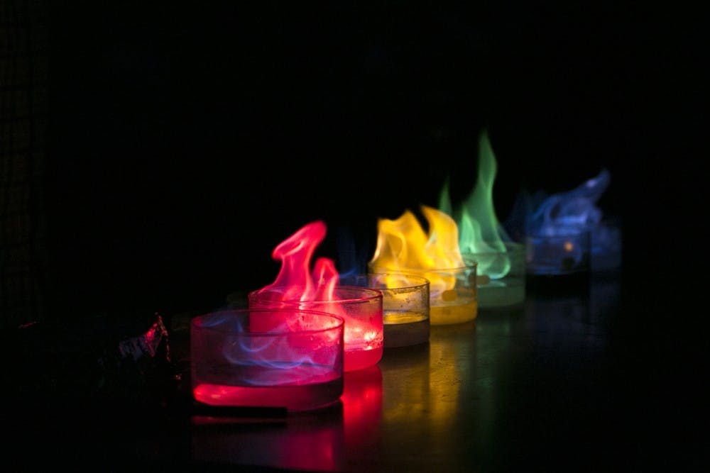 Chemistry professor James H. Geiger creates colorful flames by lighting an assortment of elements on fire during Keep Calm: It's Only An Explosion which is a chemistry demonstration going on as a part of the MSU Science Festival on April 14, 2016, in the Chemistry Building. Geiger says he likes demonstrating chemistry because he wants to spark interest for both adults and children to learn more about chemistry.