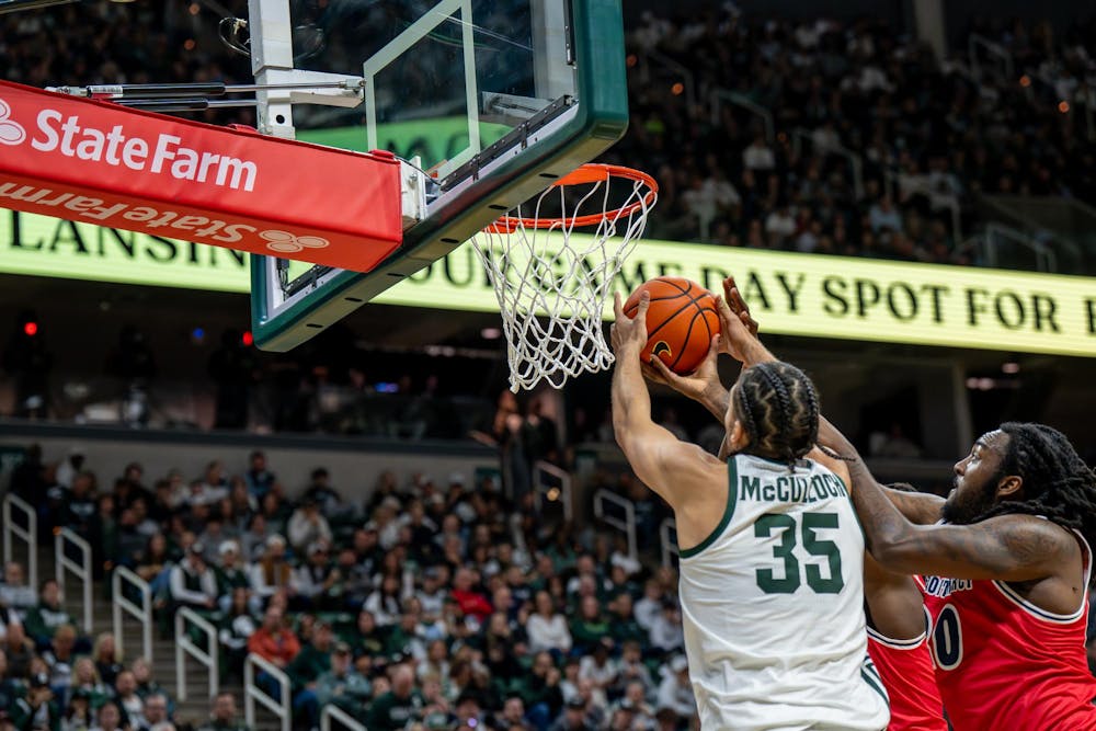 Michigan State forward Jesse McCulloch (35) attempts a shot as Detroit Mercy forward London Maiden (20) tries to block it during the Spartans’ game at the Breslin Center in East Lansing, Mich., on Friday, Nov. 21, 2025.