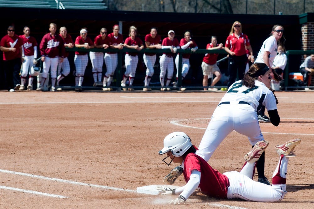 	<p>Junior pitcher Lauren Kramer looks for a throw as Indiana infielder Cassie Gogreve slides her way to safety Saturday afternoon at Secchia Stadium. Matt Hallowell/The State News</p>