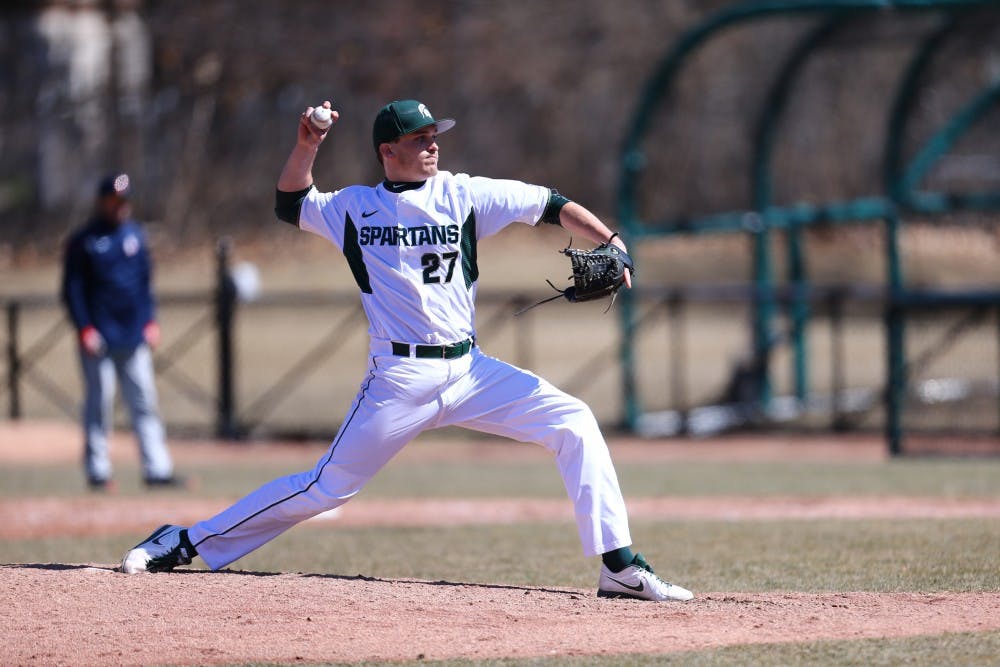 <p>Mick VanVossen winds up a pitch at the MSU student clinic on March 28. Photo: Rey Del Rio/MSU Athletic Communications</p>