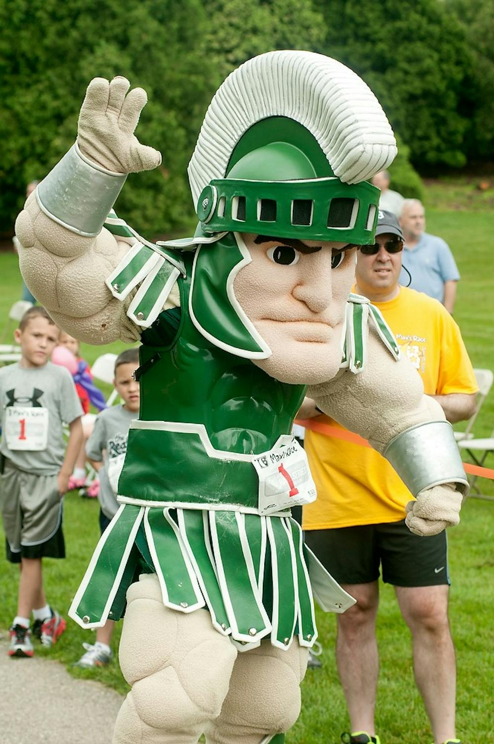 <p>MSU mascot Sparty gets ready to give a high five during the ninth annual Max’s race 5K on June 29, 2013, outside the Auditorium.</p>