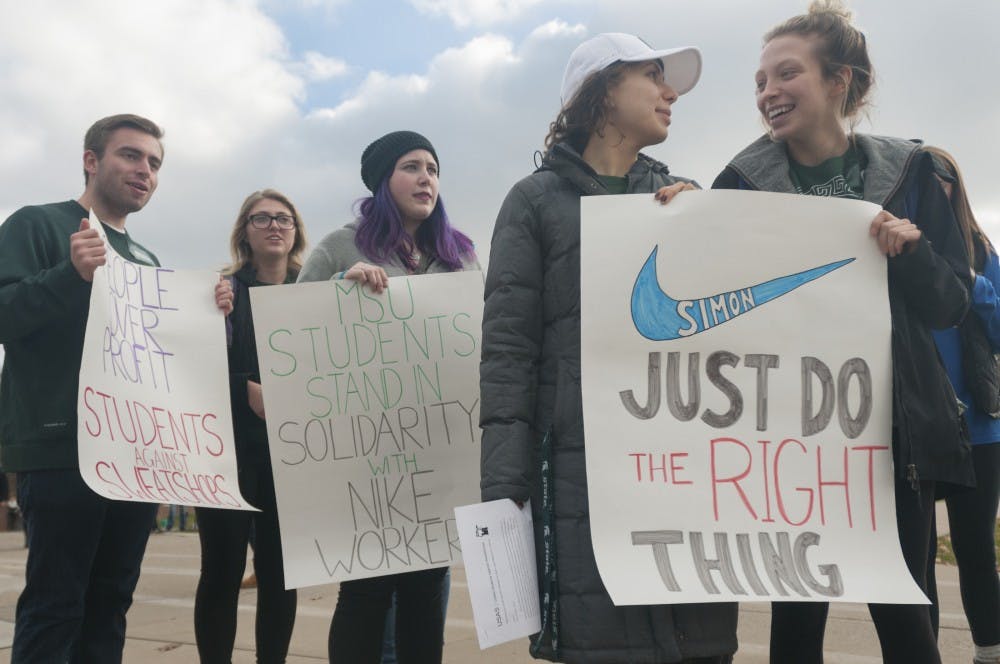 Members of MSU's chapter of United Students Against Sweatshops walk from Shaw Hall to Hannah Administration Building on Nov. 16, 2016. The students delivered a letter to the Office of the President requesting that MSU confront Nike about allegations of worker's rights violations.