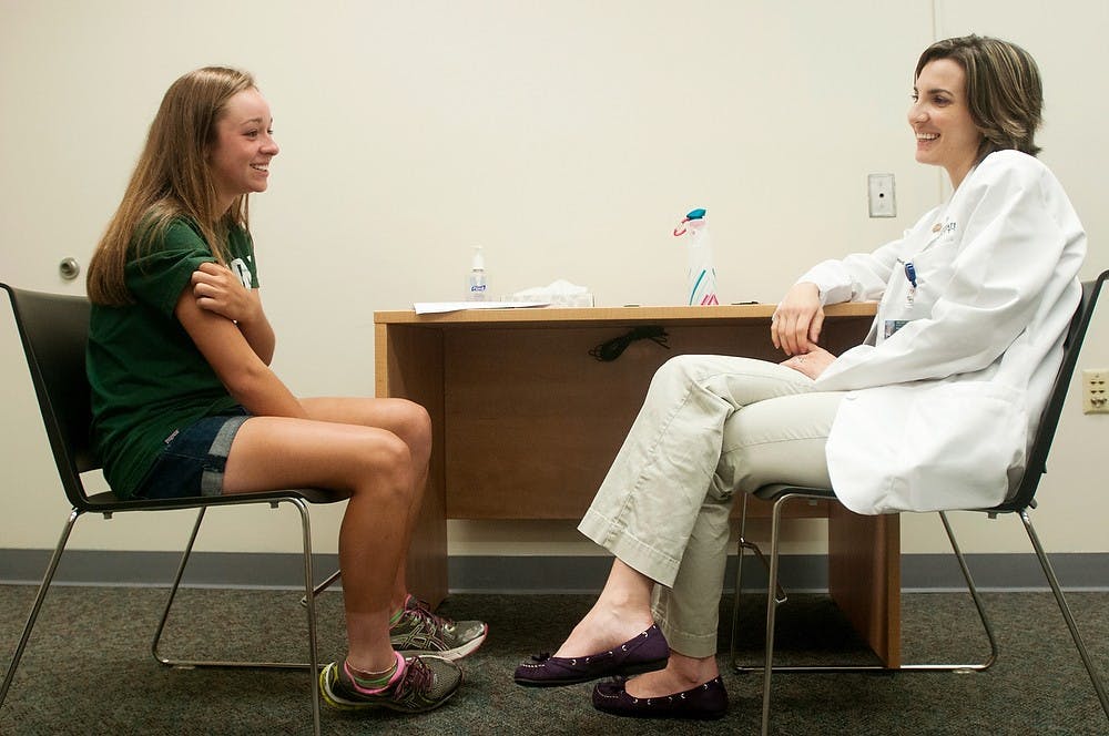 	<p>Holt, Mich., resident Emily Struble, 15, speaks with first-year medical student Veronica Arbuckle-Bernstein during a mock physician&#8217;s exam, June 12, 2013, at the Clinical Center. The medical students interview the mock patients for 30 minutes about different aspects of their lives. Danyelle Morrow/The State News</p>