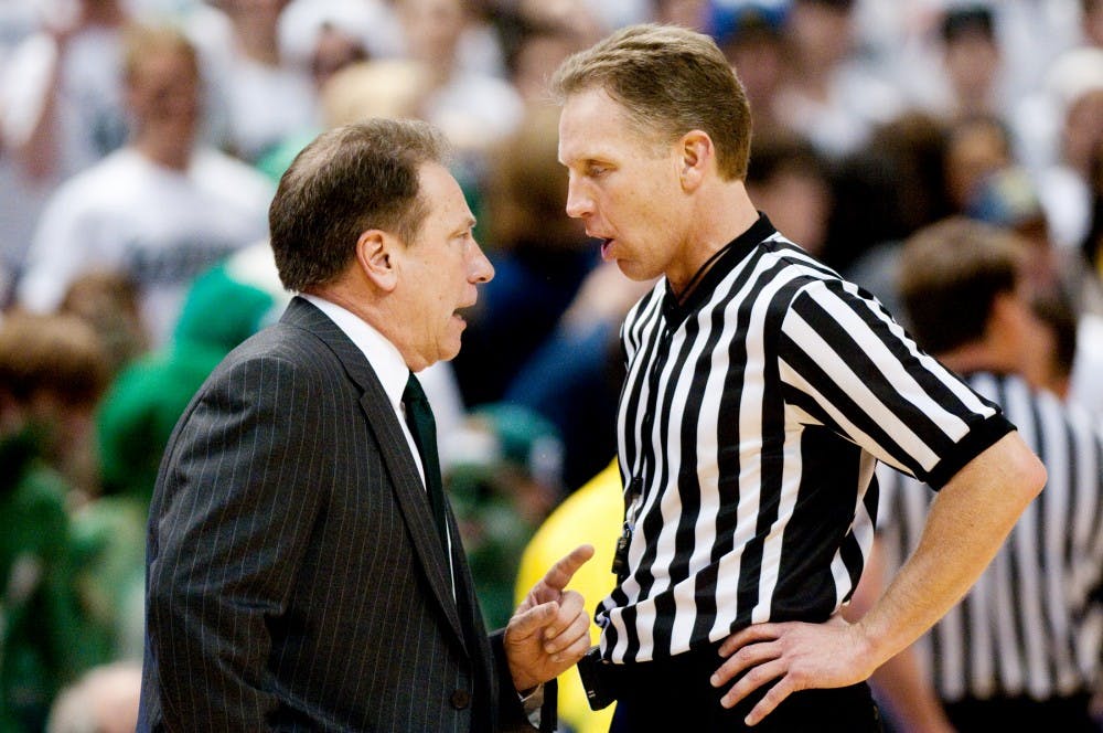 Head coach Tom Izzo speaks with an official after a foul was called on junior center Derrick Nix Sunday afternoon at Breslin Center. The Spartans defeated Michigan 64-54. Matt Hallowell/The State News