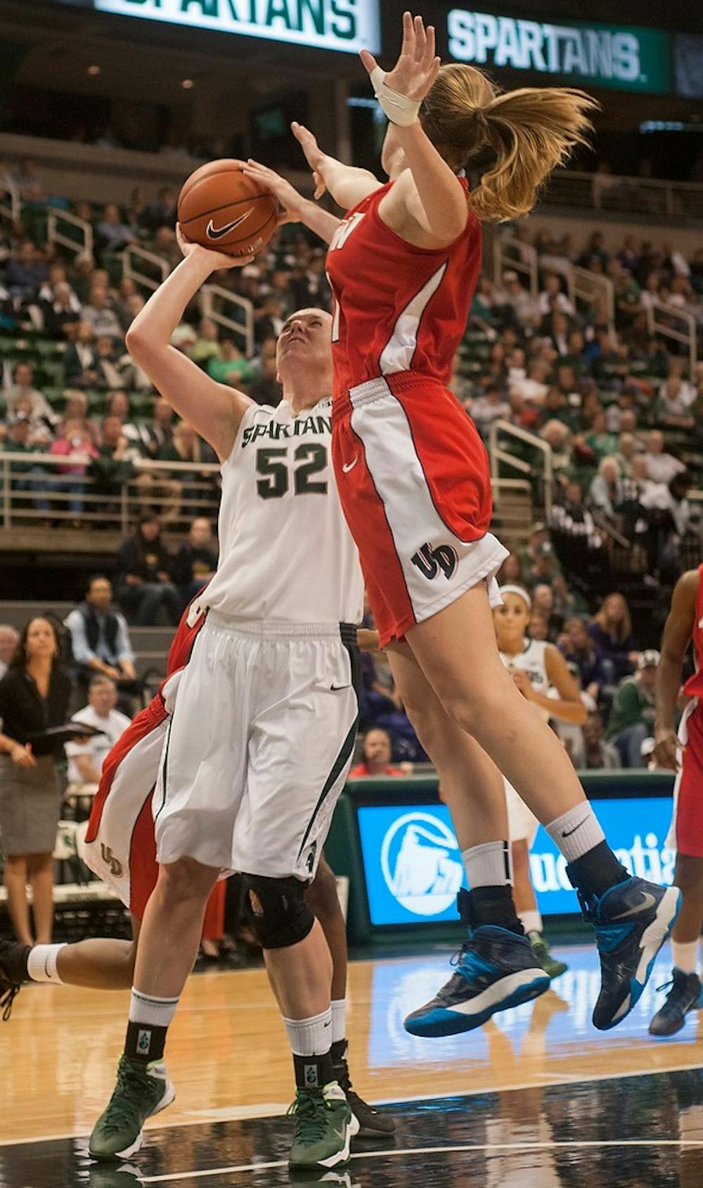 	<p>Junior forward Becca Mills takes a shot next to Dayton Junior forward Ally Malott on Nov. 17, 2013, at Breslin Center. <span class="caps">MSU</span> defeated Dayton in overtime, 96-89. Brian Palmer/The State News</p>