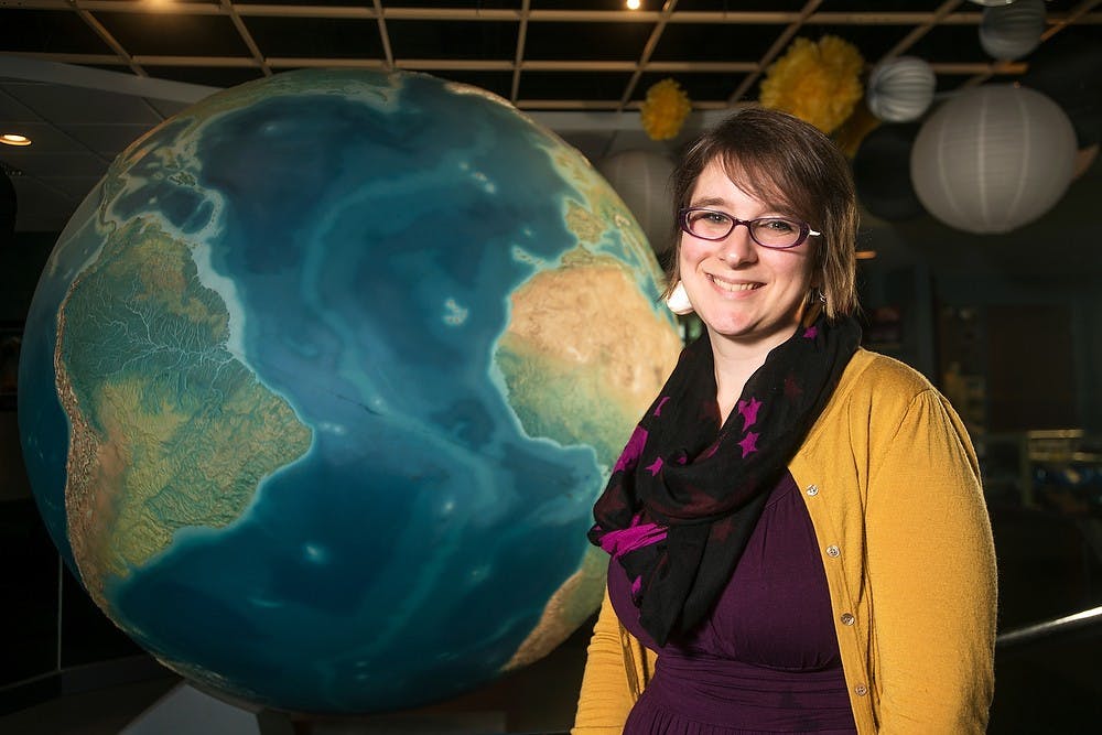 <p>Abrams Planetarium Director Shannon Schmoll poses for a portrait July 16, 2014, at Abrams Planetarium. This year marks the planetarium's 50th anniversary. Corey Damocles/The State News </p>