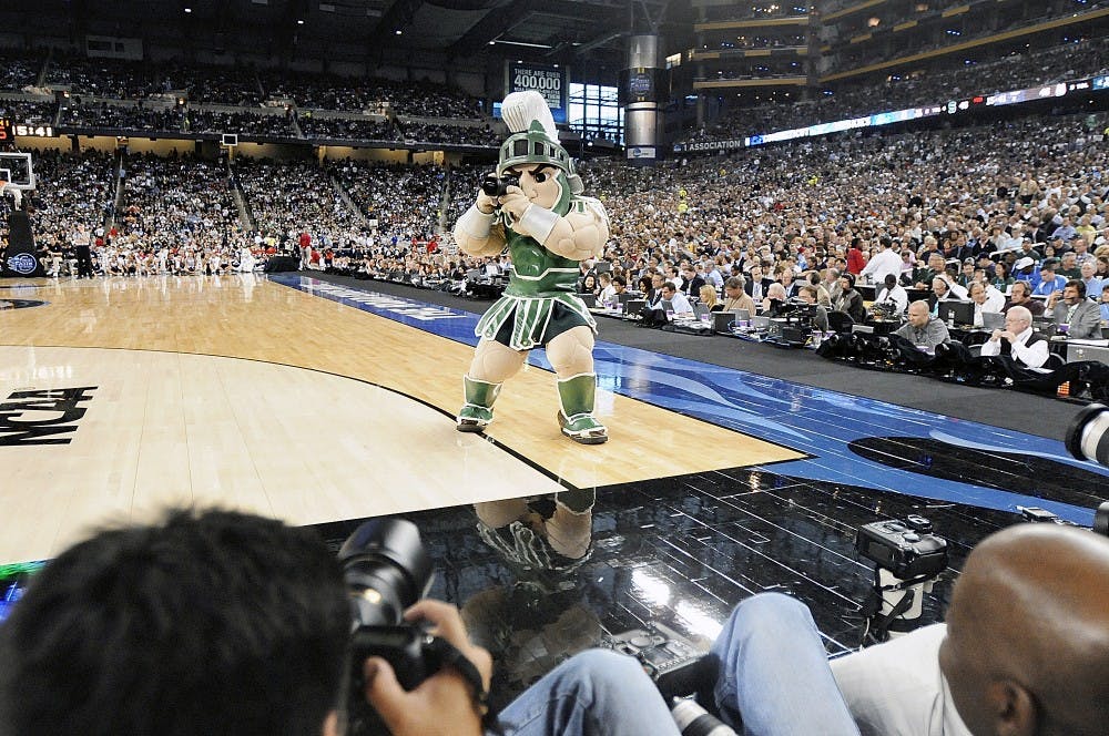 <p>Sparty borrows a photographer&#x27;s camera to do a little shooting of his own during a time out on April 4, 2009, at NCAA Final Four matchup between MSU and Connecticut at Ford Field in Detroit. State News File Photo.</p>