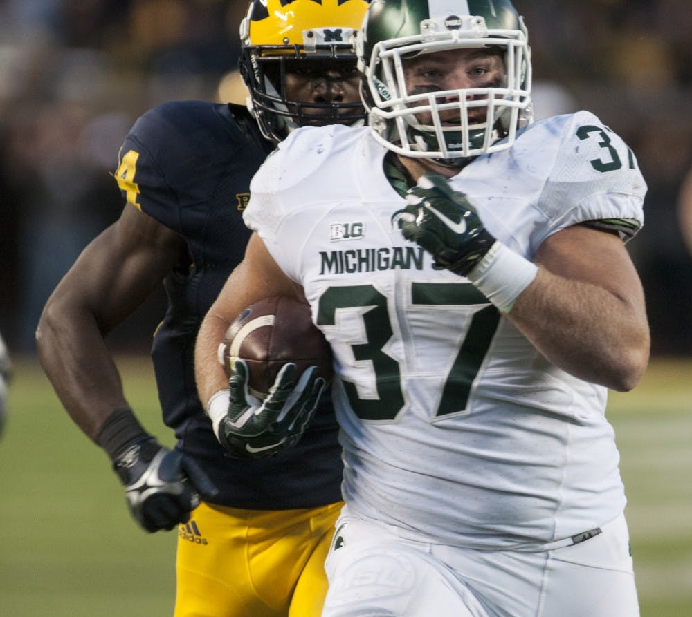 <p>Senior fullback Trevon Pendleton runs the ball to the one yard line on Oct. 17, 2015 during the fourth quarter of the game against Michigan at Michigan Stadium in Ann Arbor. The Spartans defeated the Wolverines, 27-23. </p>