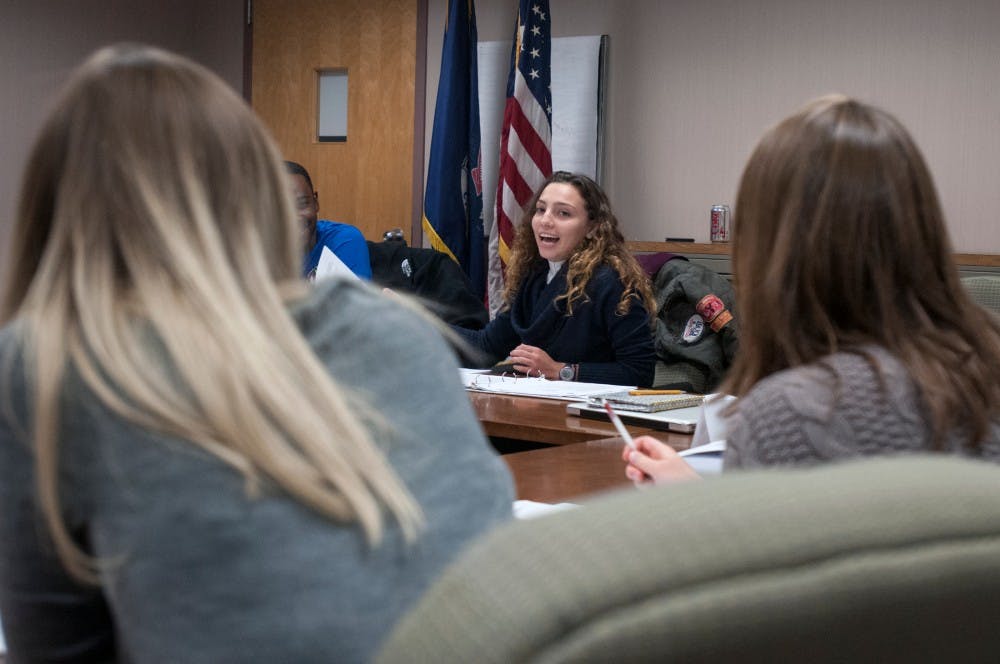 Comparative culture & politics junior Cookie Rifiotis, center, speaks during a student commission meeting on Oct. 25, 2016 at East Lansing City Hall. Rifiotis currently serves as the chair of ASMSU. 