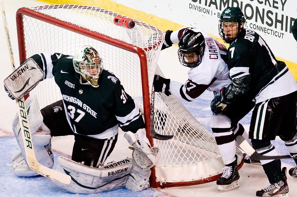 	<p>Then-senior defenseman Tim Buttery pushes Union forward Daniel Ciampini into the net while then-sophomore goaltender Will Yanakeff shifts left to stop the puck on March 23 in Bridgeport, Conn. Now a junior, Yanakeff looks to lead a group of young <span class="caps">MSU</span> goalies. State News file photo</p>