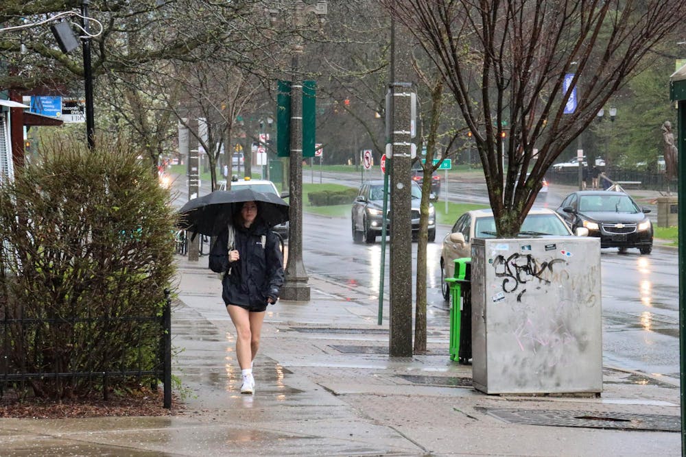 <p>Wednesday afternoon, students can be seen going about their day while withstanding severe storms on Grand River Ave, on April 17, 2024. </p>