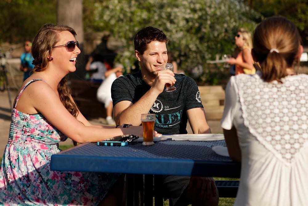 	<p>Williamston, Mich., residents Cristy Clark, left, and Jeremy Bloom share a laugh May 16, 2013, at the Potter Park Zoo, 1301 S Pennsylvania Ave., in Lansing. Local and nonlocal craft breweries were in attendance. Weston Brooks/The State News</p>