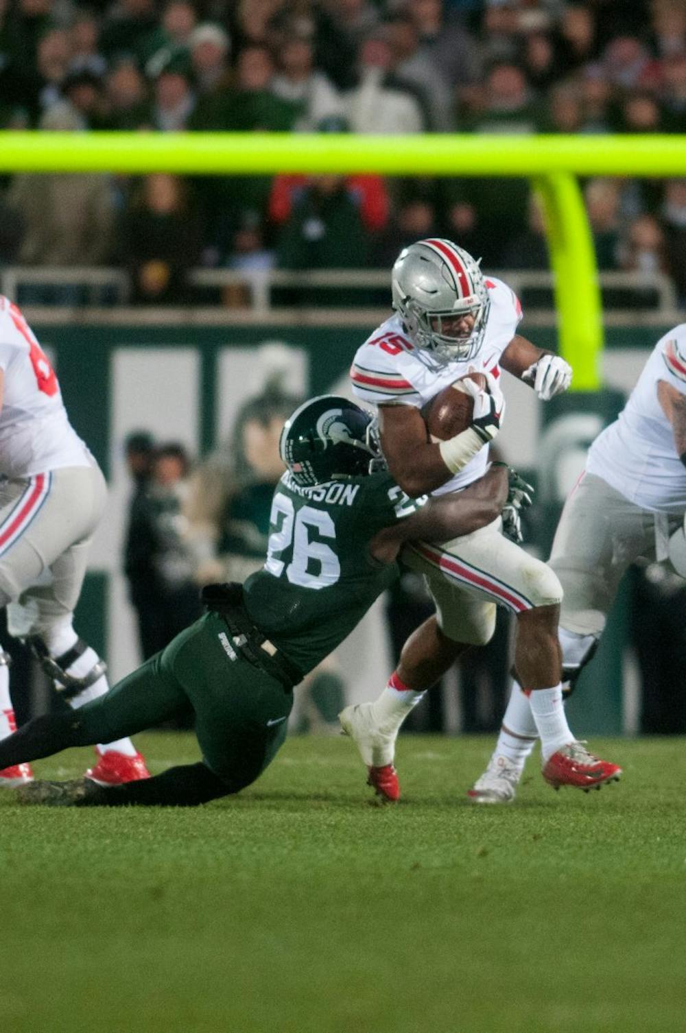 <p>Junior safety RJ Williamson tackles Ohio State running back Ezekiel Elliott during the game against Ohio State on Nov. 8, 2014 at Spartan Stadium. The Buckeyes defeated the Spartans, 49-37. Jessalyn Tamez/The State News </p>