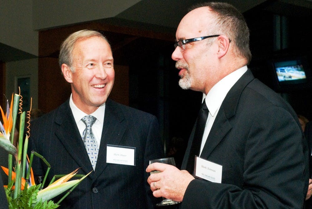 From left, chief financial officer Mark Haas laughs with the assistant dean for the college of osteopathic medicine Mark Notman on Friday night at the Spartan Lounge. Haas and Notman both attended the event in support of the Broad Museum, which is scheduled to open in April of 2012. Anthony Thibodeau/The State News
