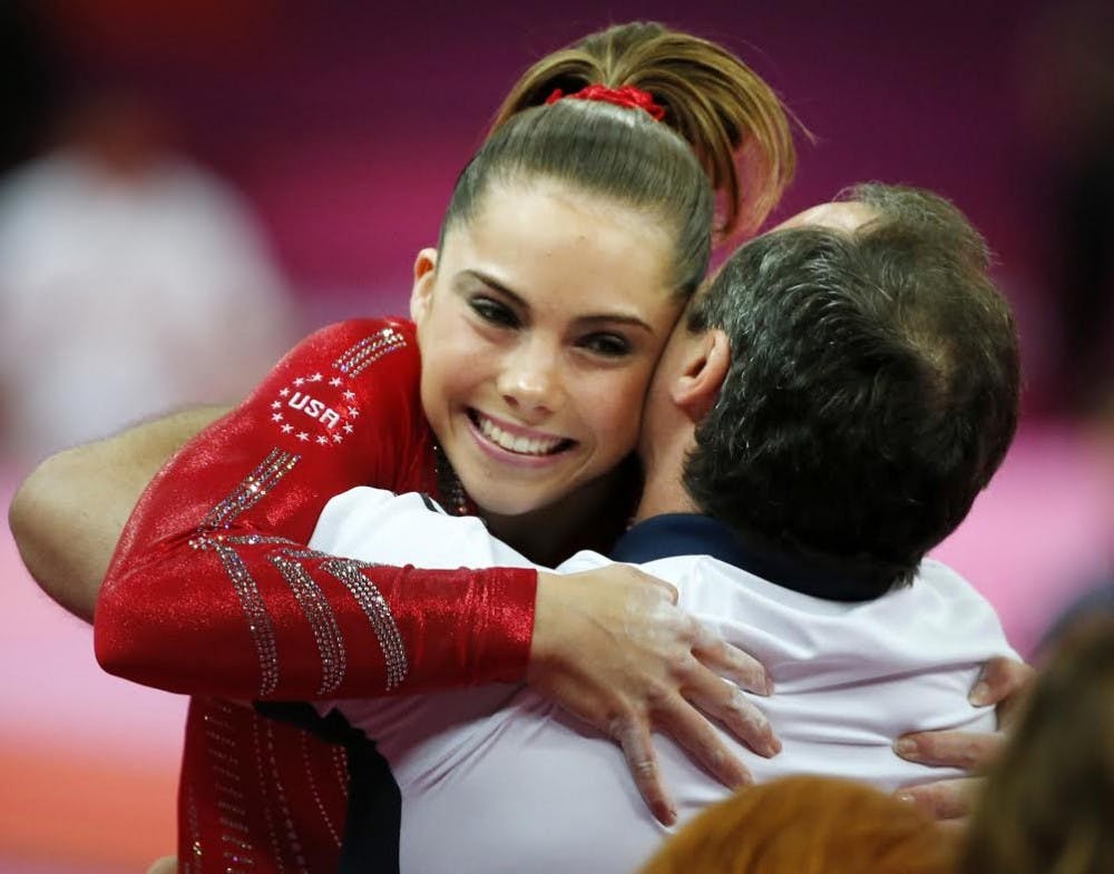 McKayla Maroney of the United States gets a hug from her coach after her performance on the vault as the U.S. women's gymnastics team goes on its way to winning gold in the team competition during the 2012 Summer Olympic Games in London, England, Tuesday, July 31, 2012. Photo: Brian Peterson/Minneapolis Star Tribune/MCT