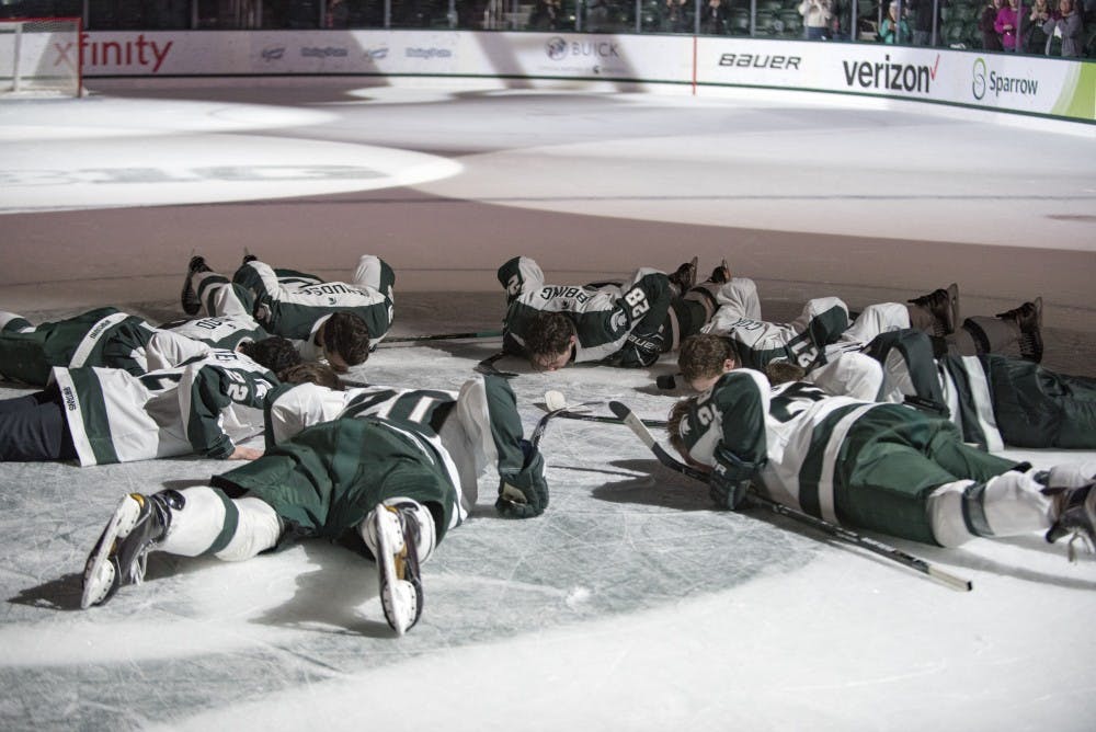 The Spartan seniors kiss the Spartan head after the game against Penn State on Feb. 25, 2017 at Munn Ice Arena. The Spartans were defeated by the Nittany Lions, 4-1