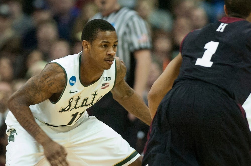 <p>Senior guard Keith Appling guards Harvard guard Siyani Chambers on March 22, 2014, at Spokane Veterans Memorial Arena in Spokane, Wash. during their second game in the NCAA Tournament. MSU won, 80-73. Betsy Agosta/The State News</p>